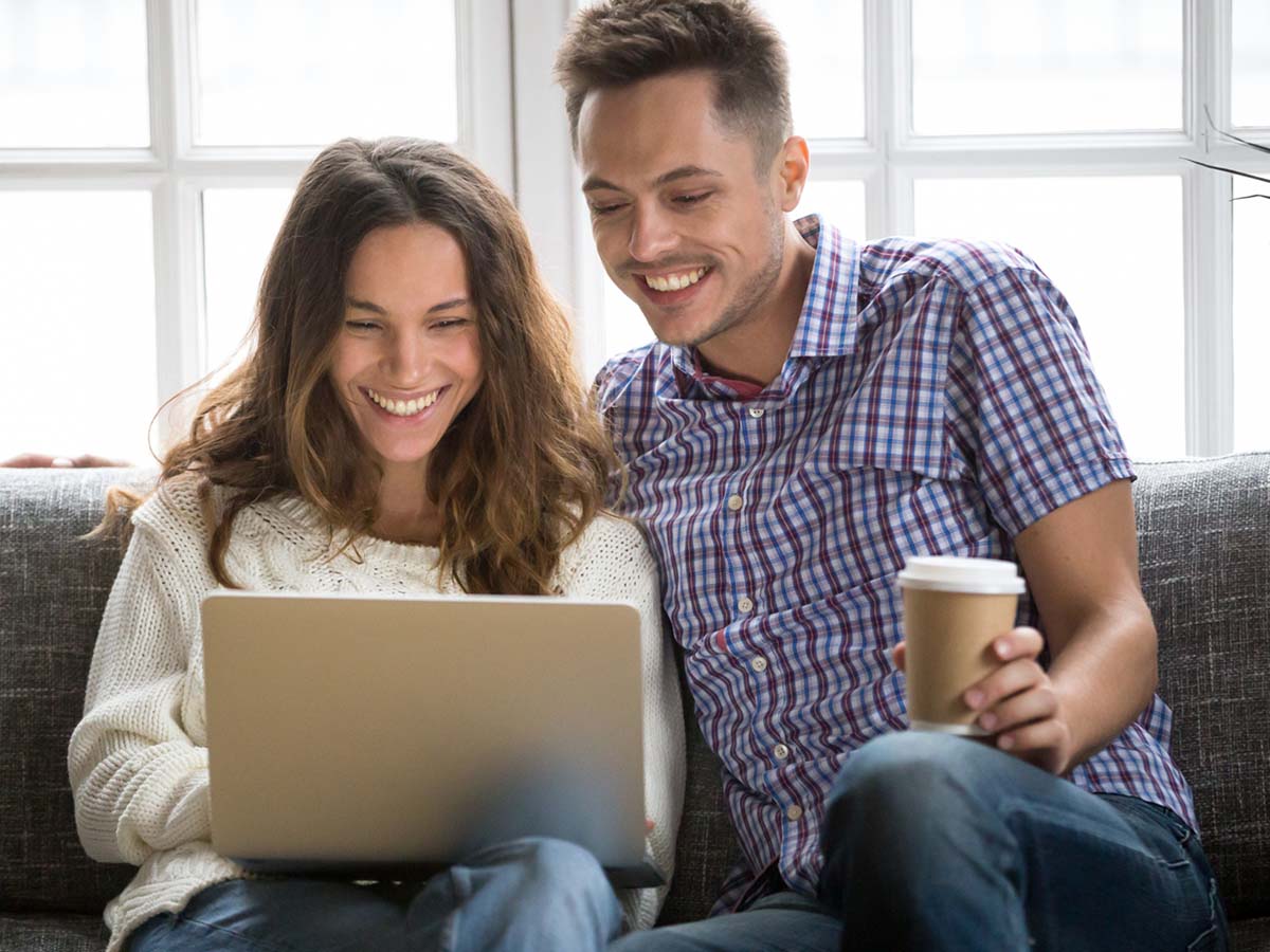 Two parents researching on a laptop