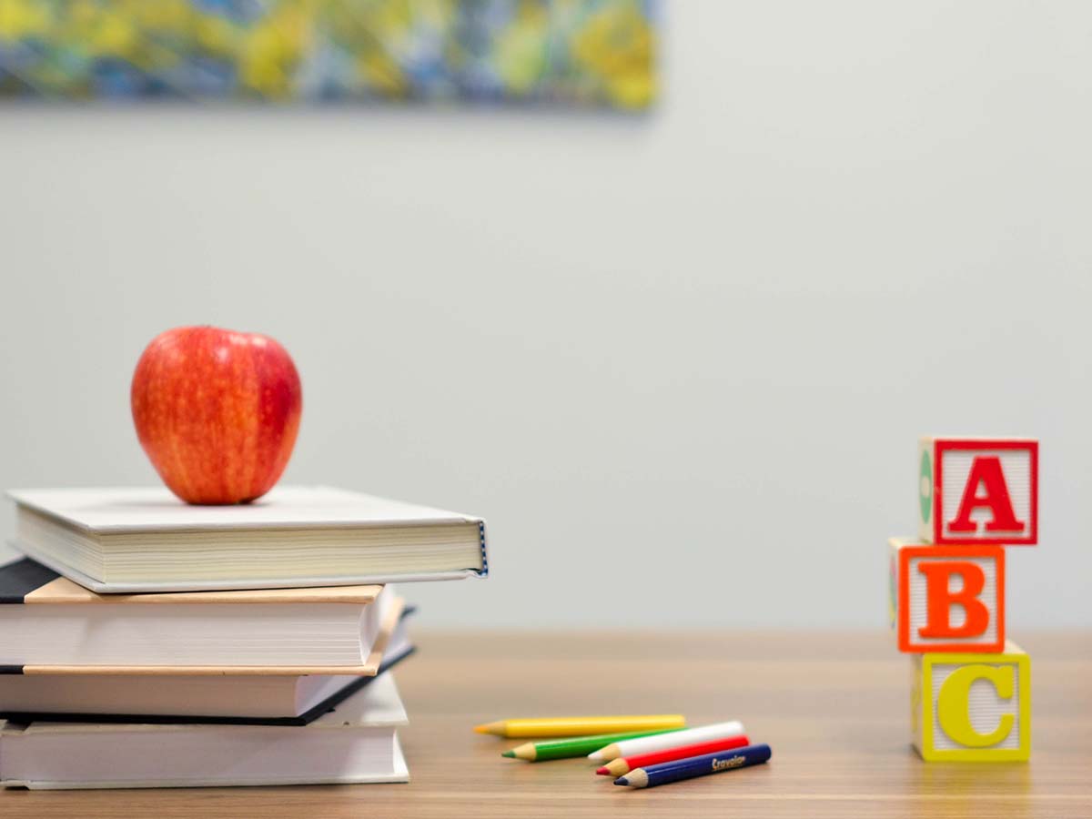 A book with an apple and some blocks