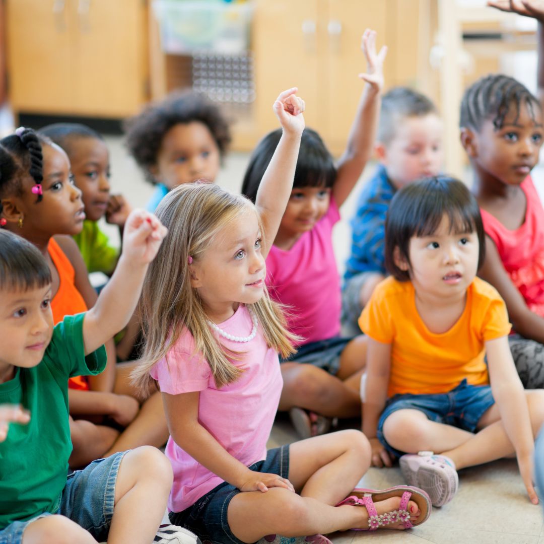 preschoolers raising hands