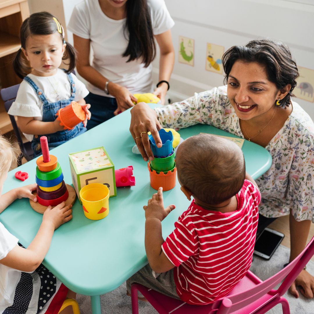Children playing with teacher at daycare