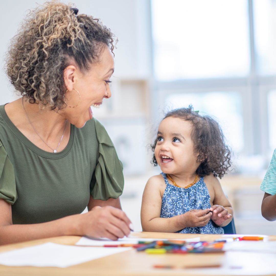 Preschool teacher and child