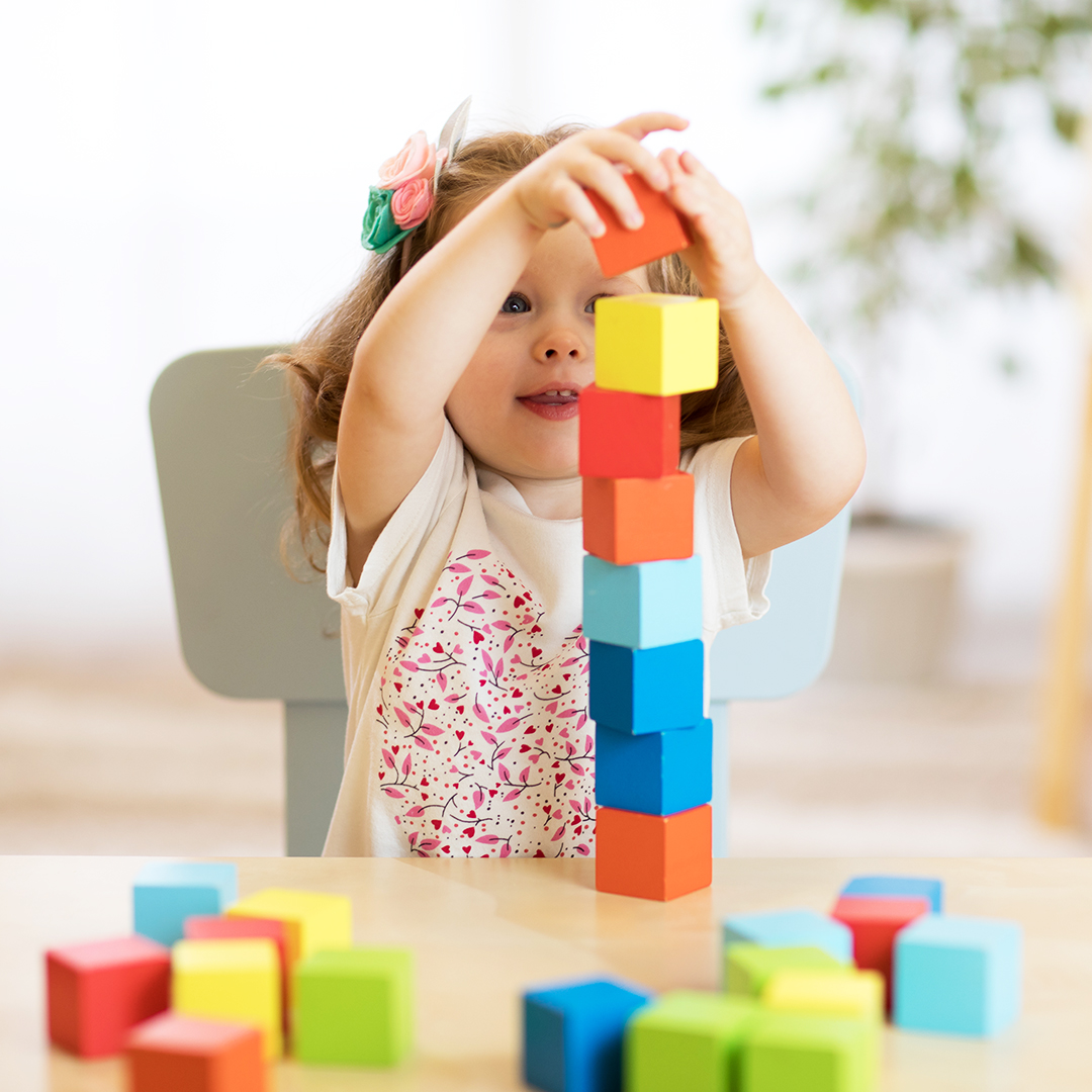 Girl stacking wood blocks