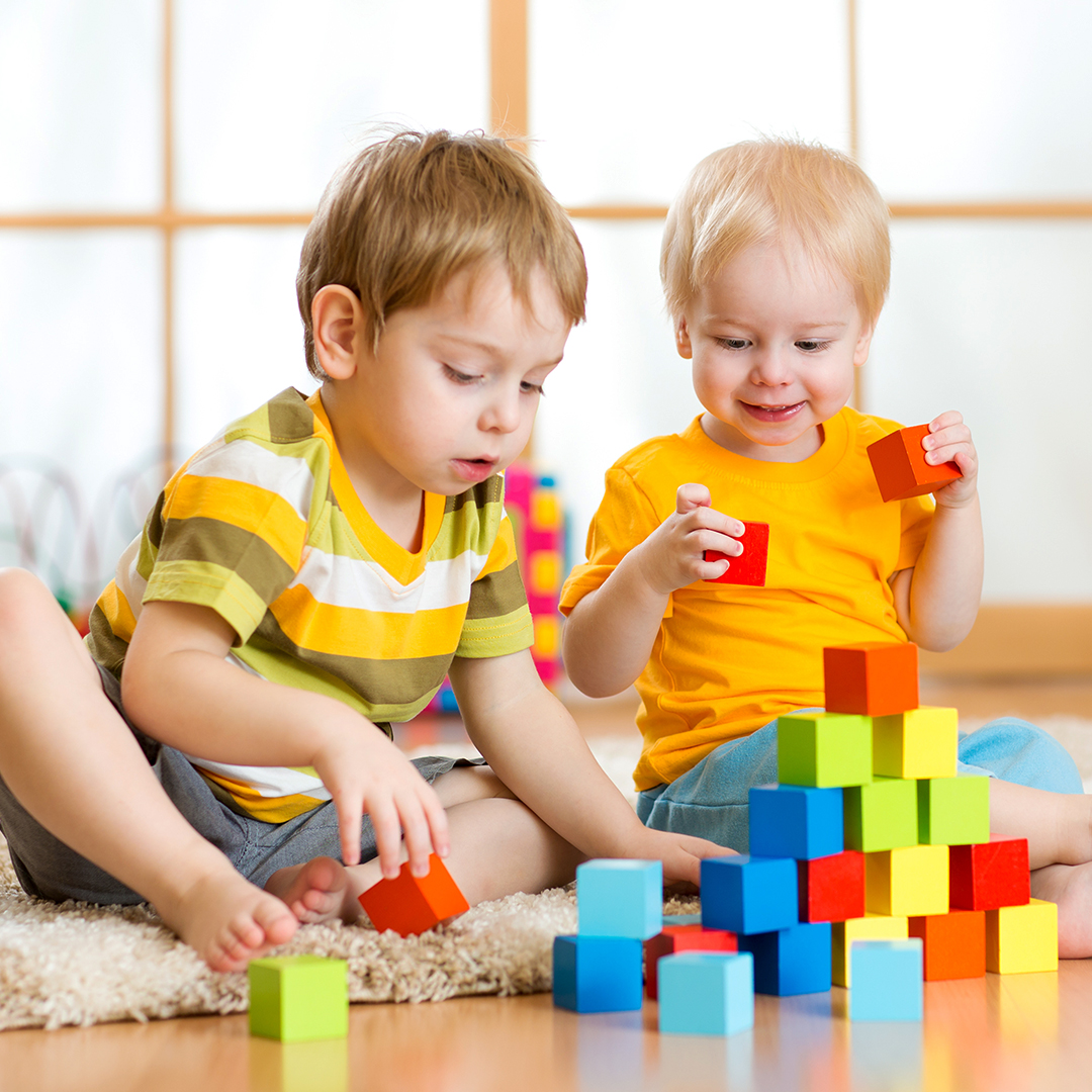Two boys playing with wood blocks