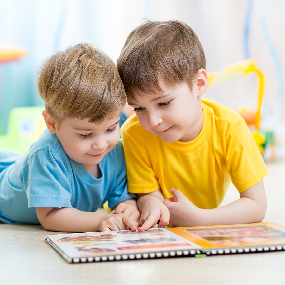 Two boys looking at a book