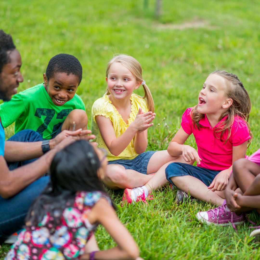 Children outside in the grass.
