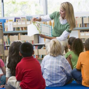 a daycare teacher reading to her class