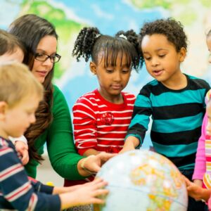 a group of daycare students learning with their teacher