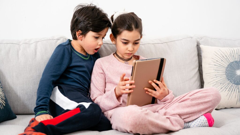 children watching something on a tablet