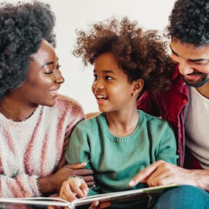 child reading with parents
