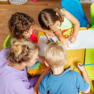 kids doing arts and crafts around a table