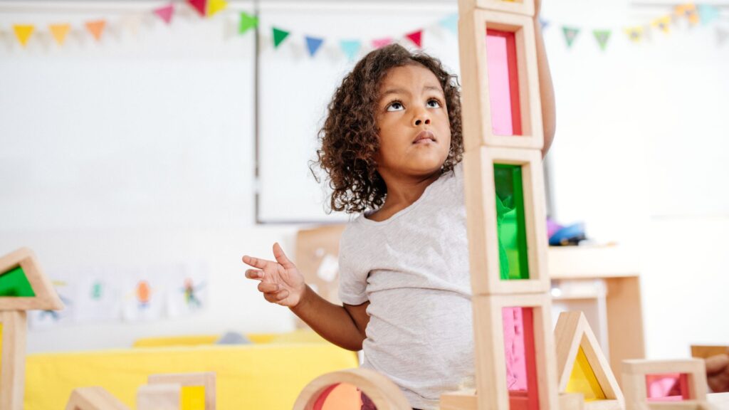 Girl stacking building blocks.