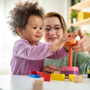 Young child playing with a problem-solving toy. 
