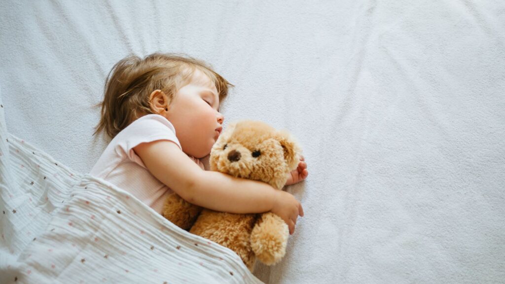 small toddler clutching her stuffed animal